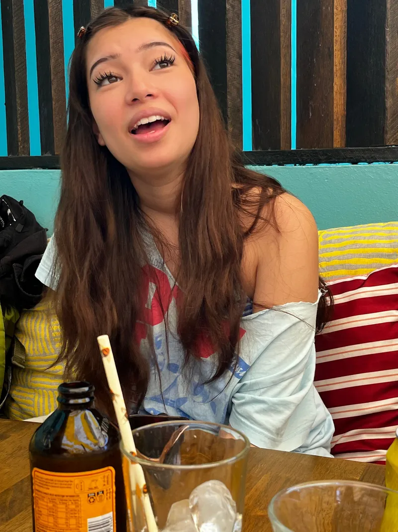The girl laughing at the cafe table