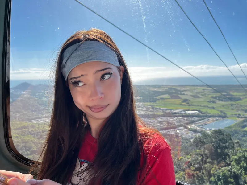 A girl in a headband pulling a face in the gondola