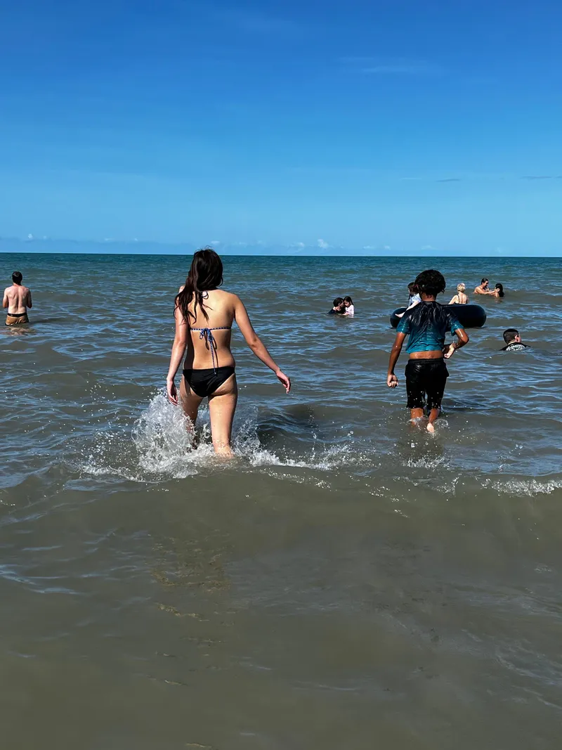 The girl and a child splashing out into the water