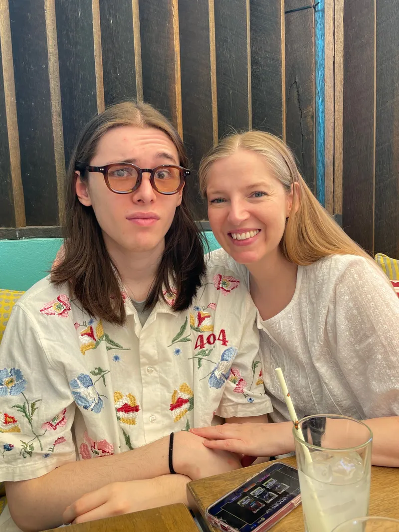 The teenager and a young woman at the cafe table