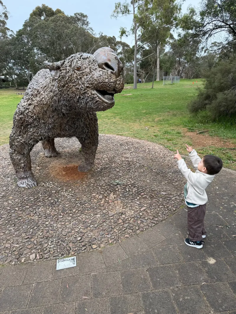 Ethan pointing up at the big bronze Diprotodon statue