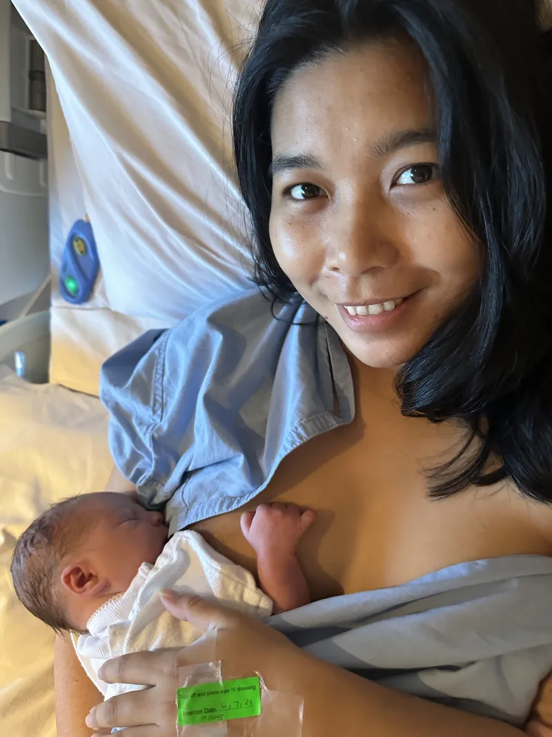 Ericka smiling as she holds newborn Ethan