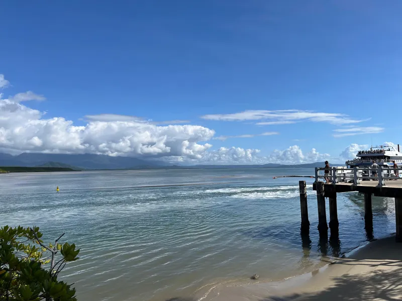 The jetty and the calm inlet, with a boat heading out