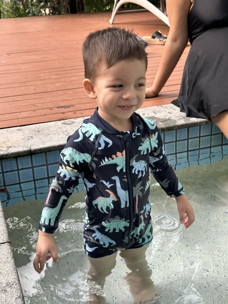 The toddler laughing in the water