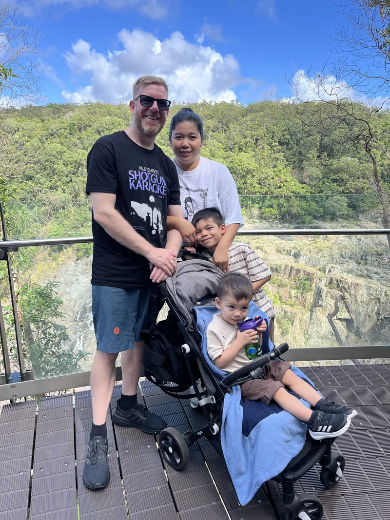 A man, a woman and two boys with the stroller at the lookout