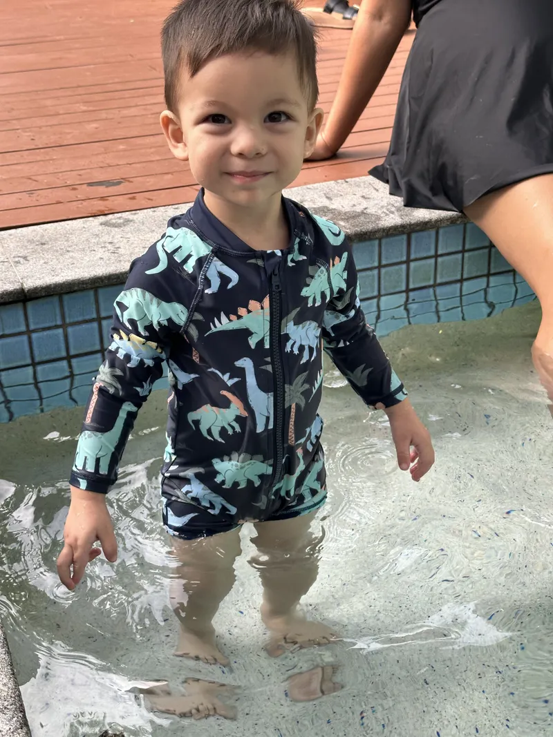 The toddler smiling at the camera
