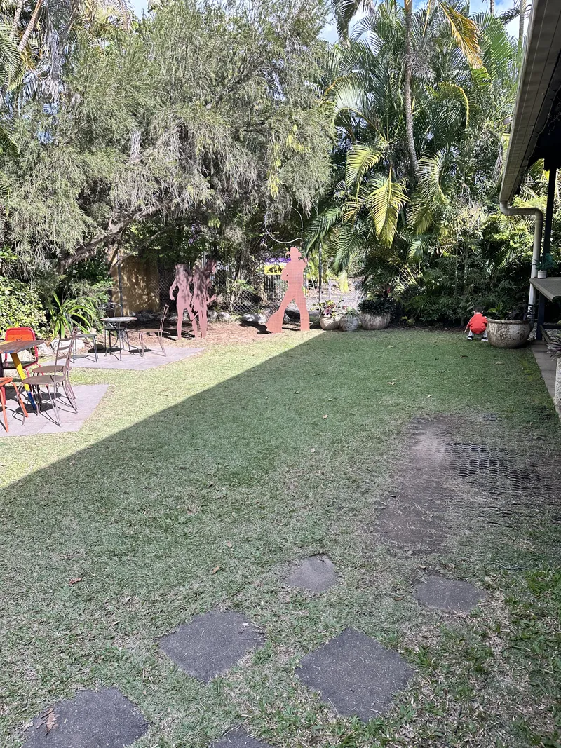 The cafe's back lawn with stepping stones and rusted metal figures