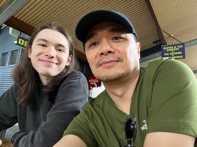 A selfie of a man and a teenager at the cafe
