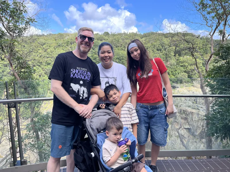A family with a toddler in a stroller at the Barron Falls lookout