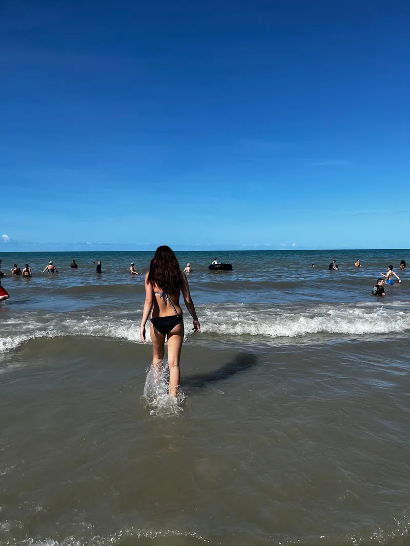A girl wading out into the sea