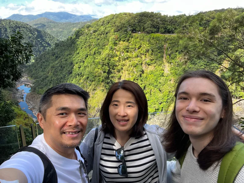 A selfie of three people at the lookout, with the gorge behind