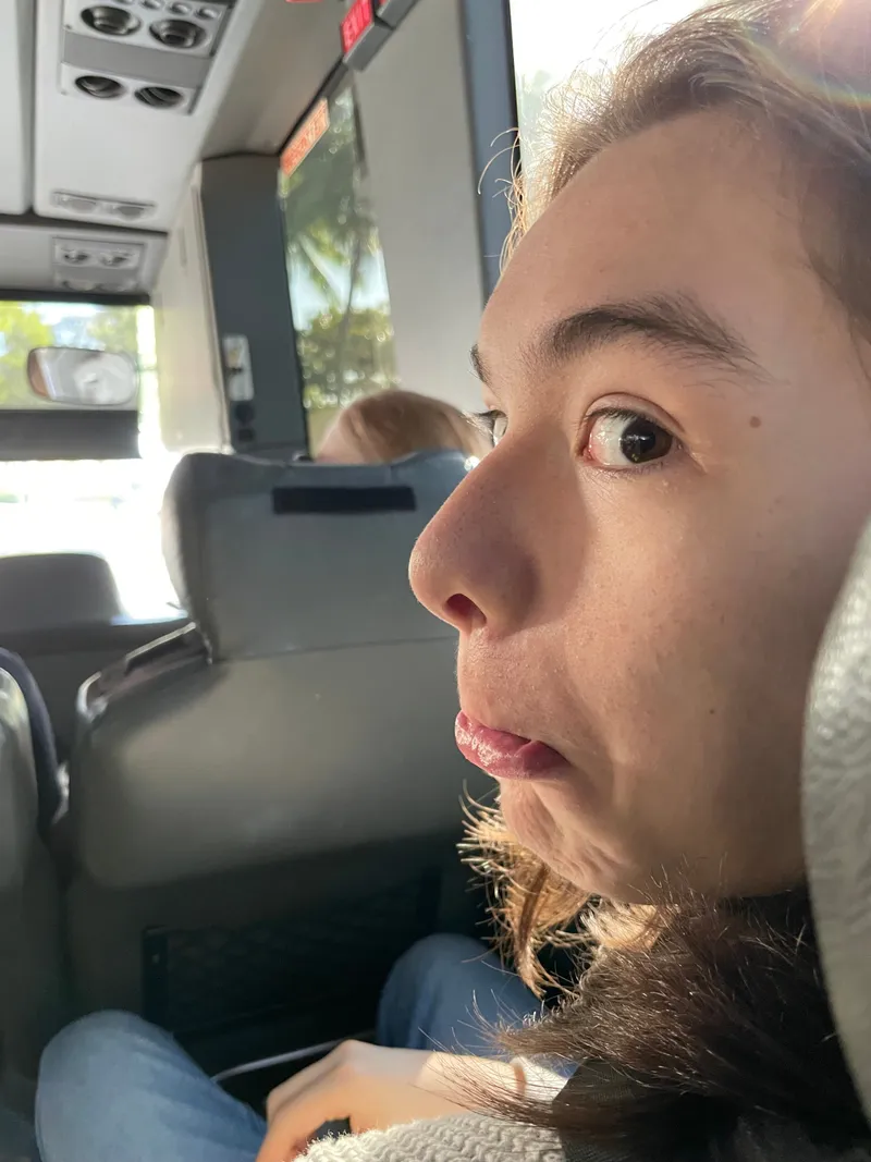 A teenager pulling a face at the camera on the bus