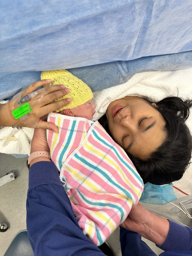 Ericka resting with newborn Ethan in hospital