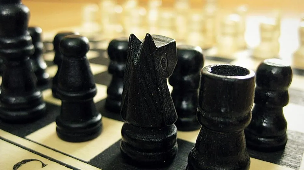 Black chess pieces on a board