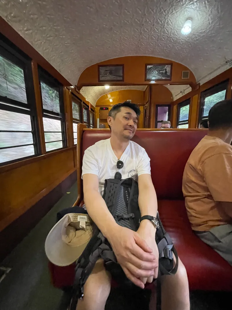 A man sitting in the carriage, a hat on his knee