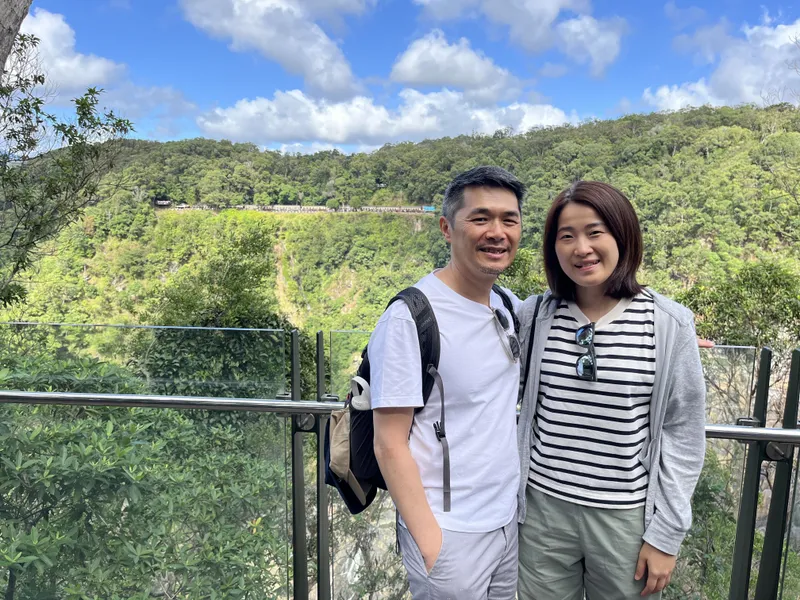 Two people at the glass lookout over the gorge