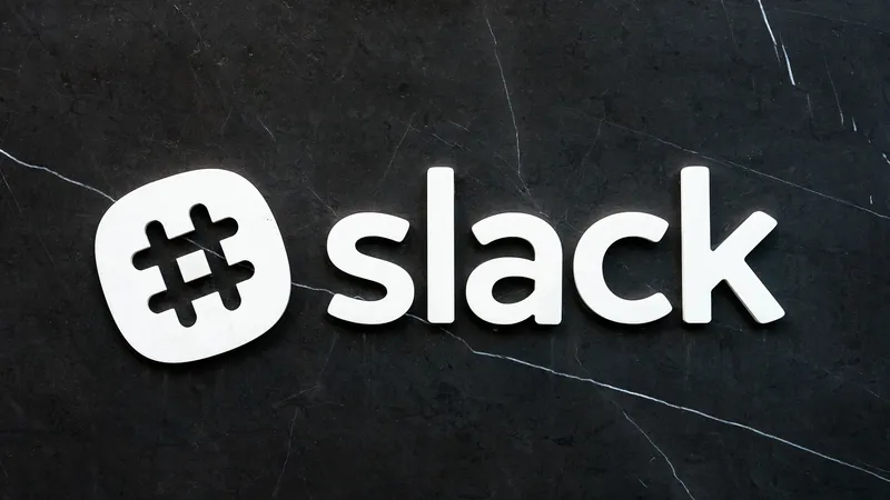 The Slack logo on a dark marble background