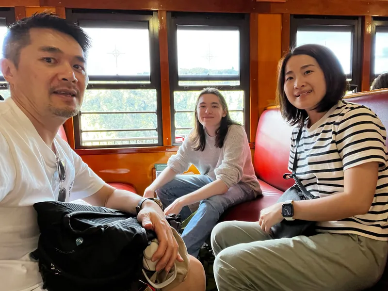 A selfie of a man, a teenager and a woman in the carriage