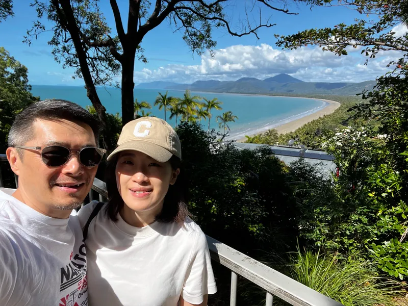 A selfie of two people at Flagstaff Hill, with Four Mile Beach below