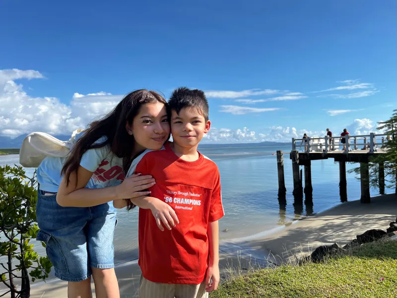 A girl hugging a boy by the jetty