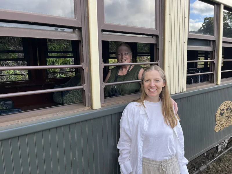 The woman smiling beside the carriage