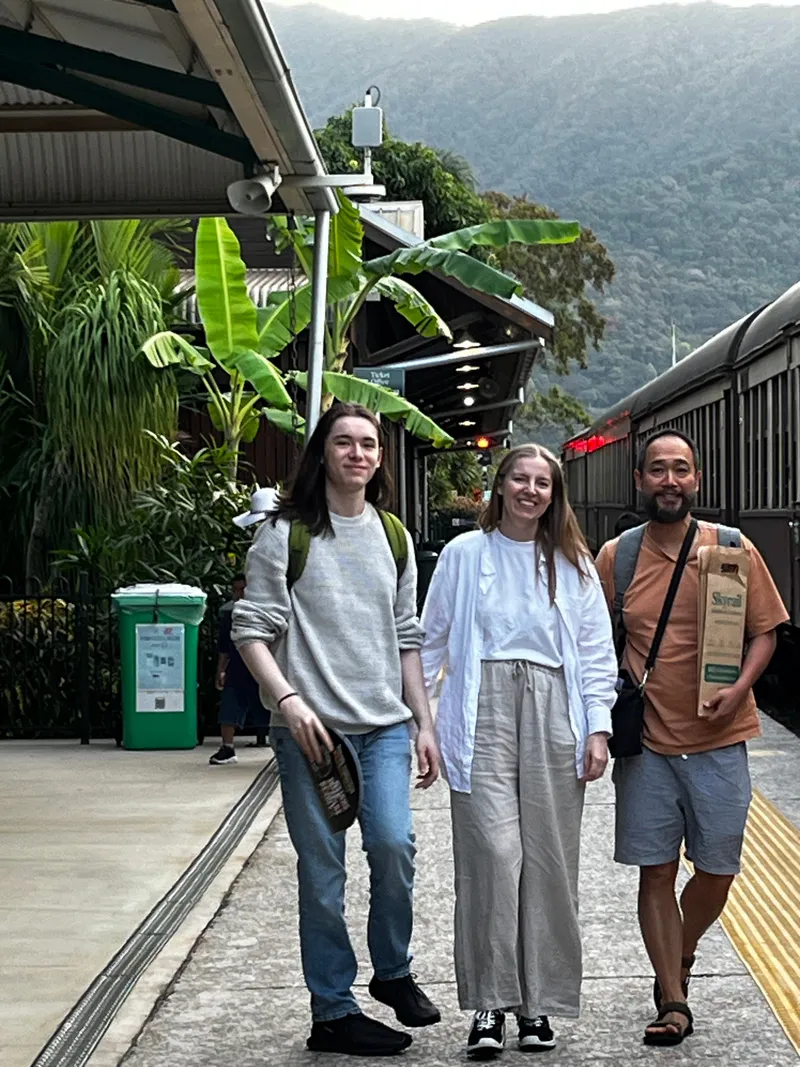 Three people walking along the platform at the end of the line