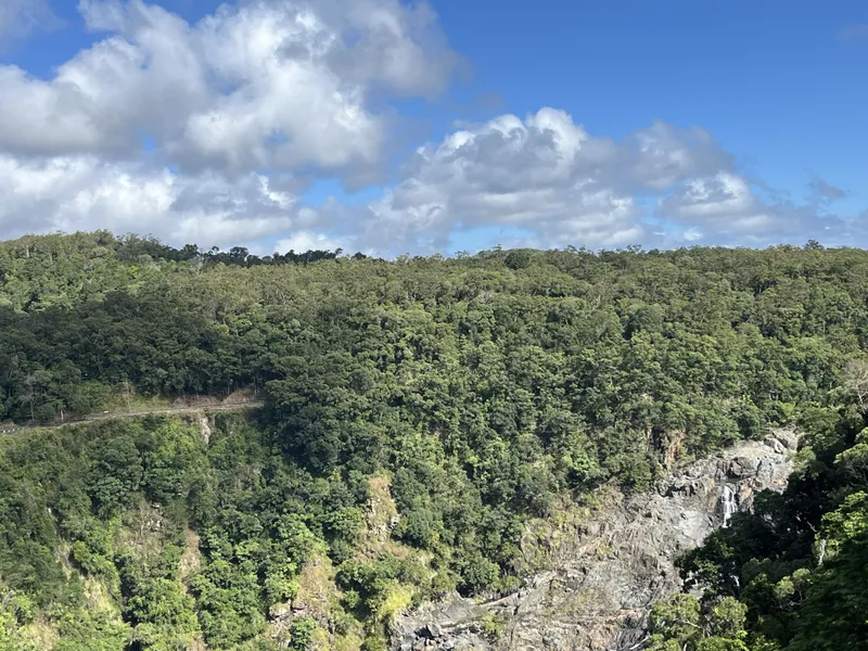 The Kuranda railway line cut into the hillside above the falls