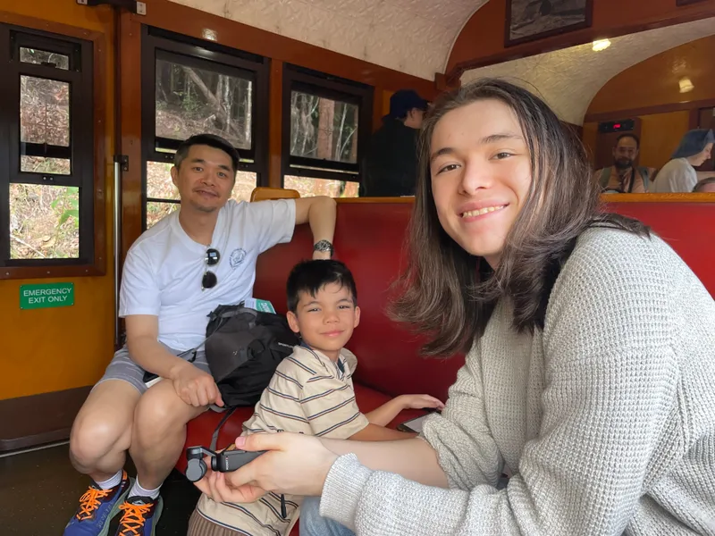 A man, a boy and a teenager in the carriage
