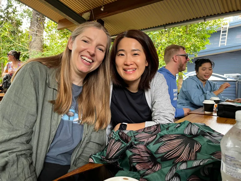 Two women smiling at a cafe table