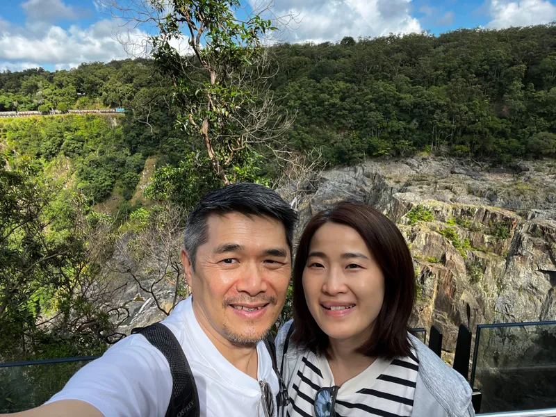 A selfie of two people above the falls