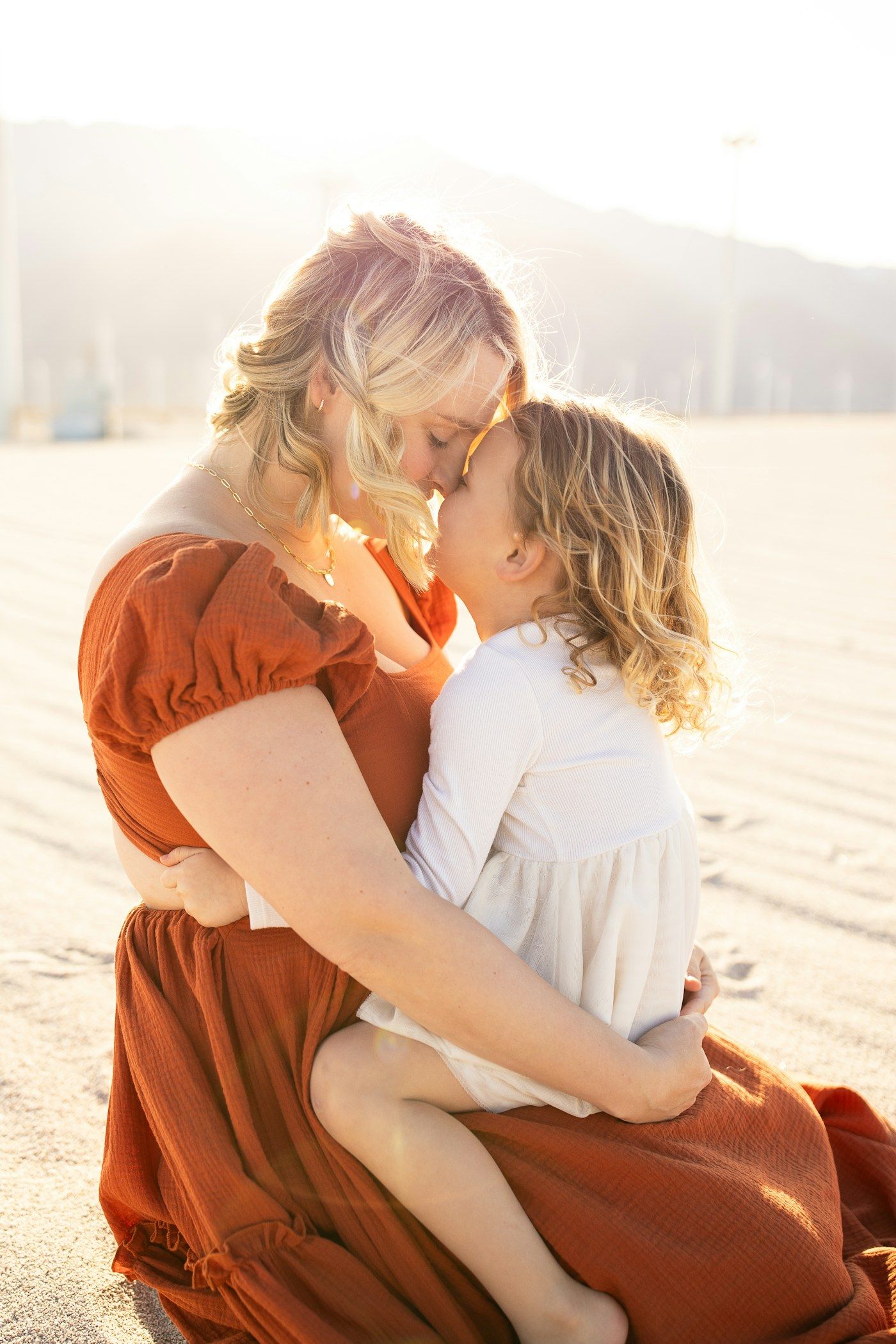 Mother holding her daughter in warm evening light