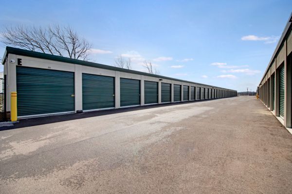 Long row of drive-up self-storage units with roll-up doors