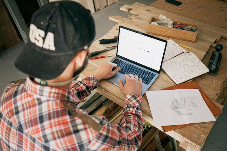 Contractor reviewing plans at a workbench