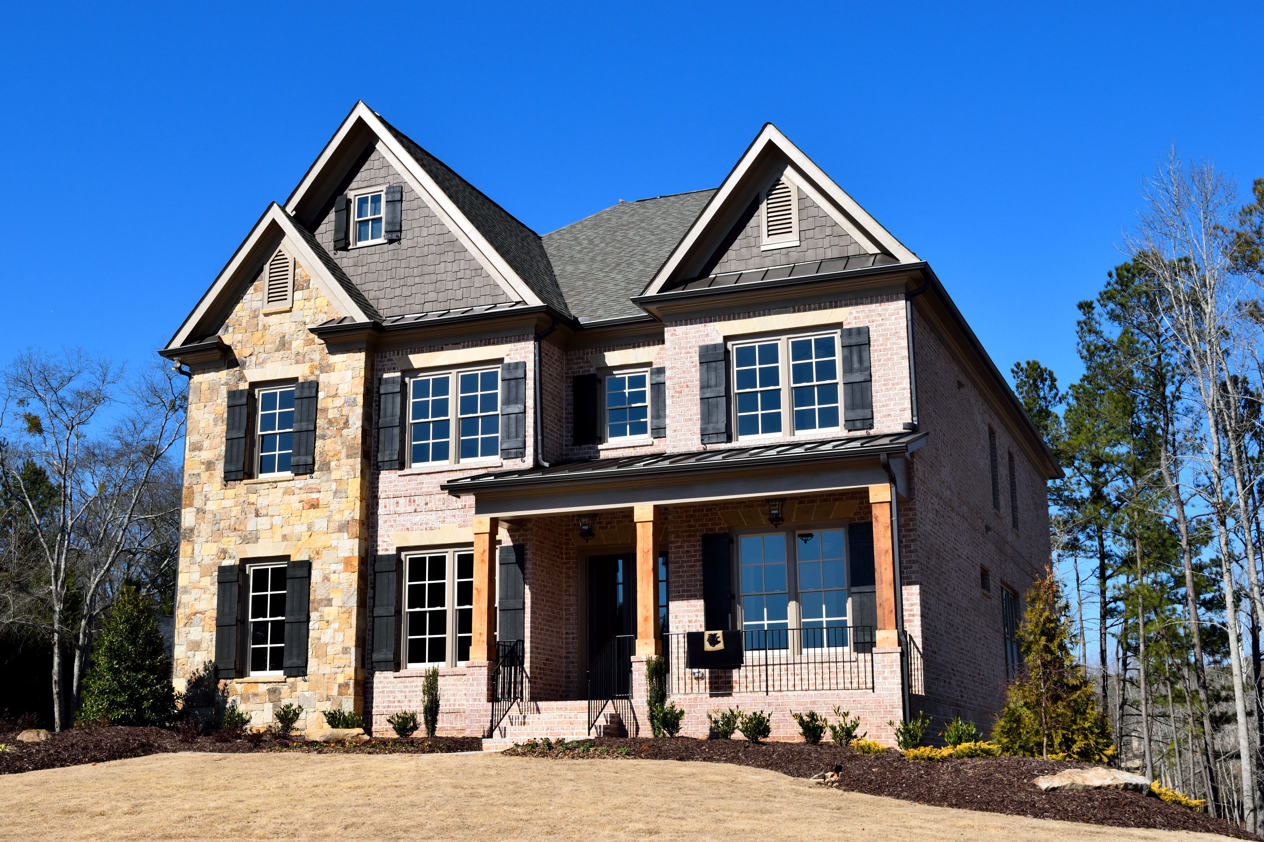 Modern two-story home with a light brick and stone exterior