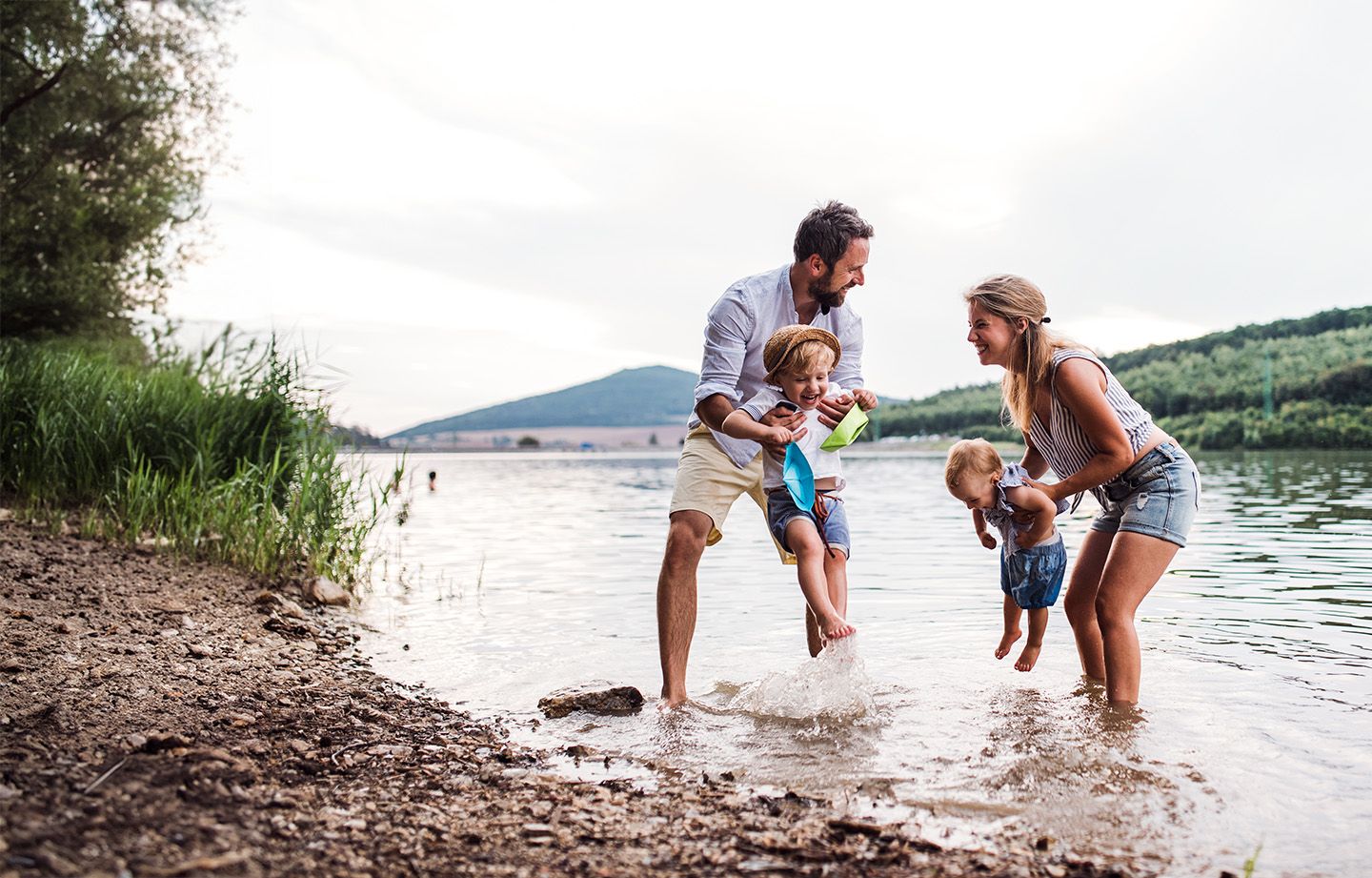 Parents and young children enjoying time together at a lakeside