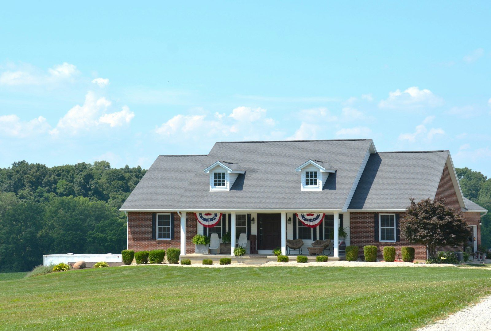 Brick house with a porch and green lawn