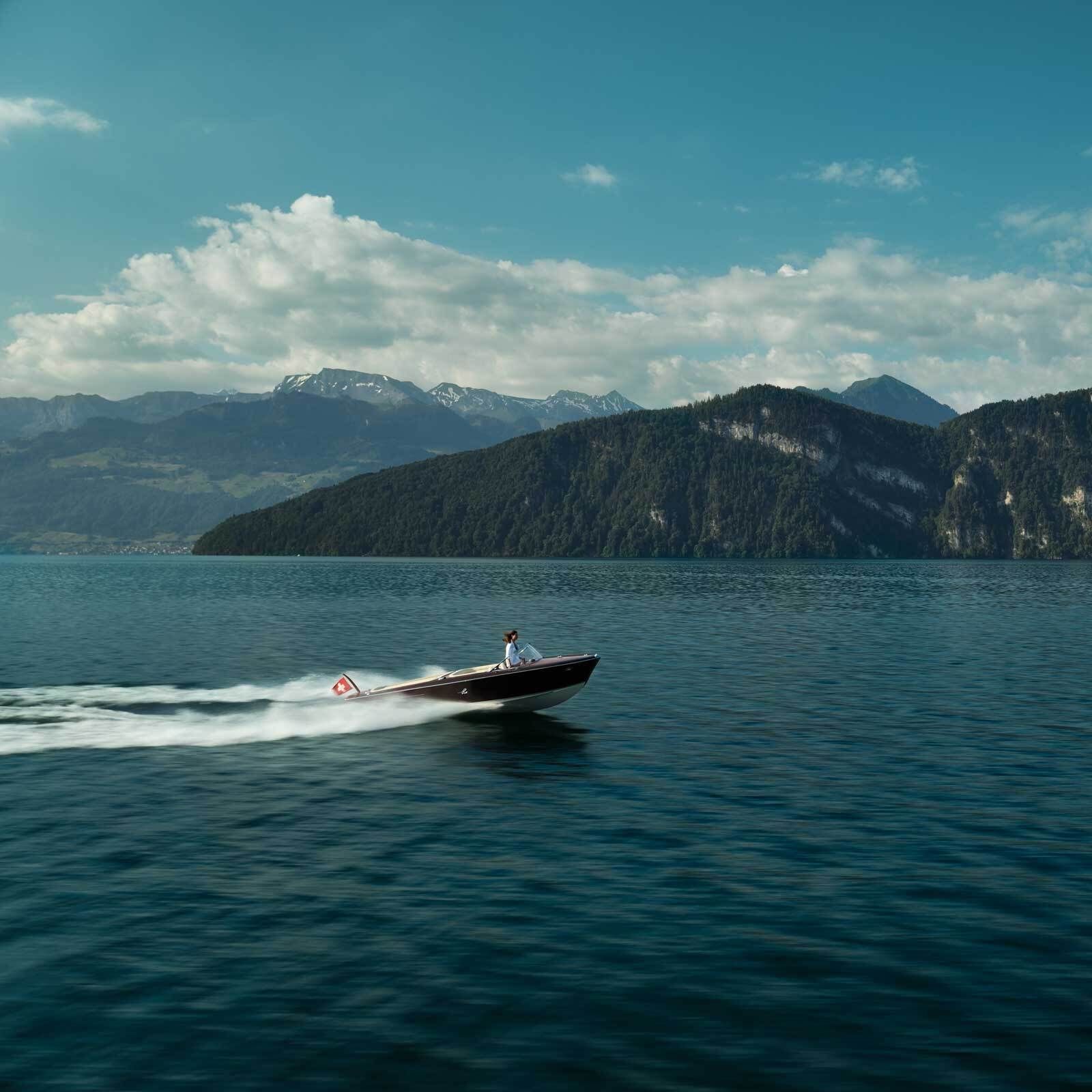 Speedboat running across open lake water