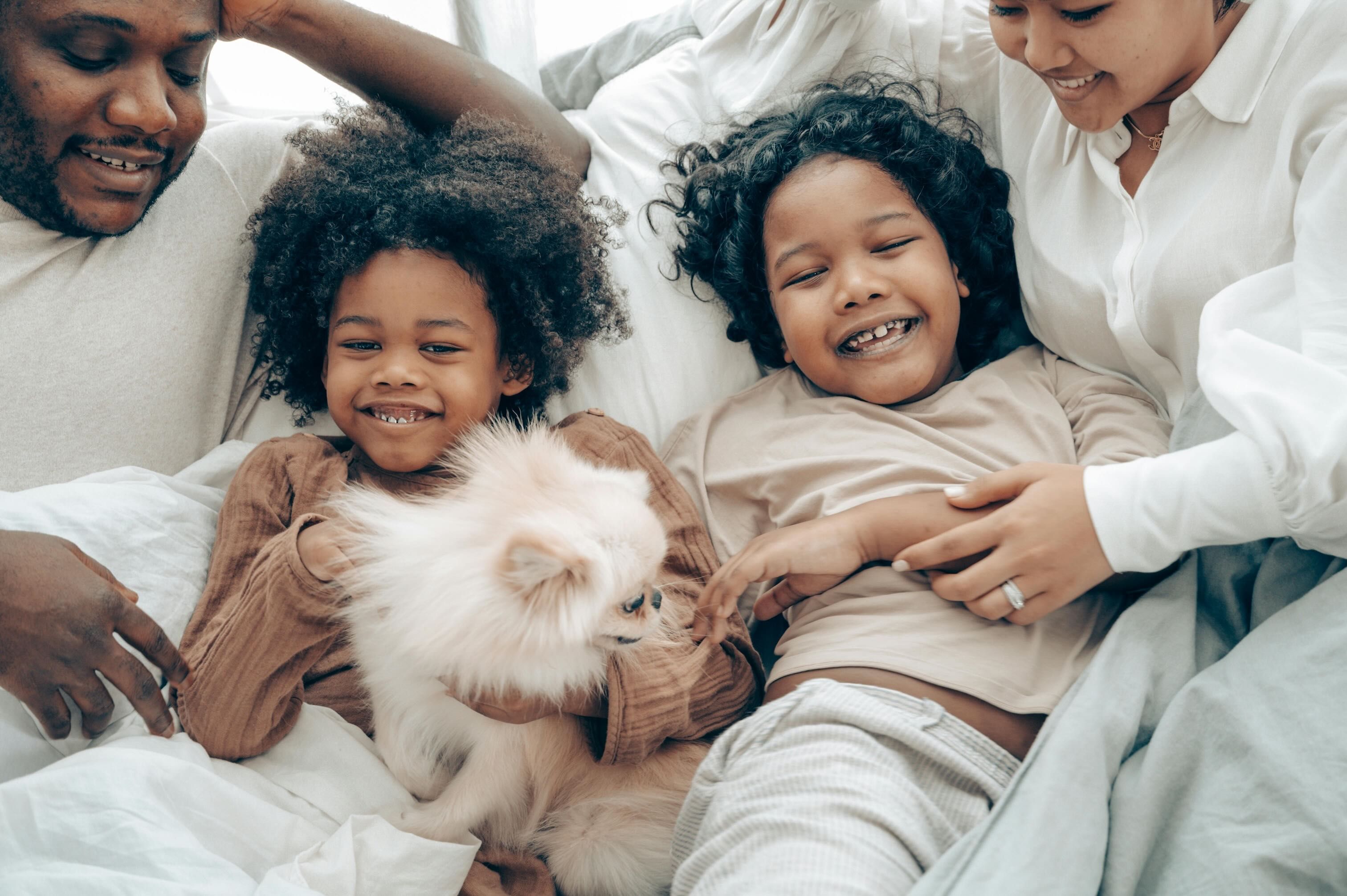 Family relaxing together with their dog