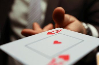 gambler with an ace playing at high low card game