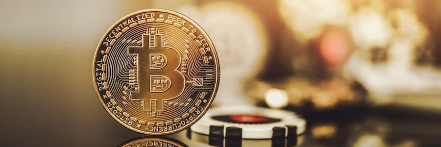 bitcoin with casino chips in the background for gambling