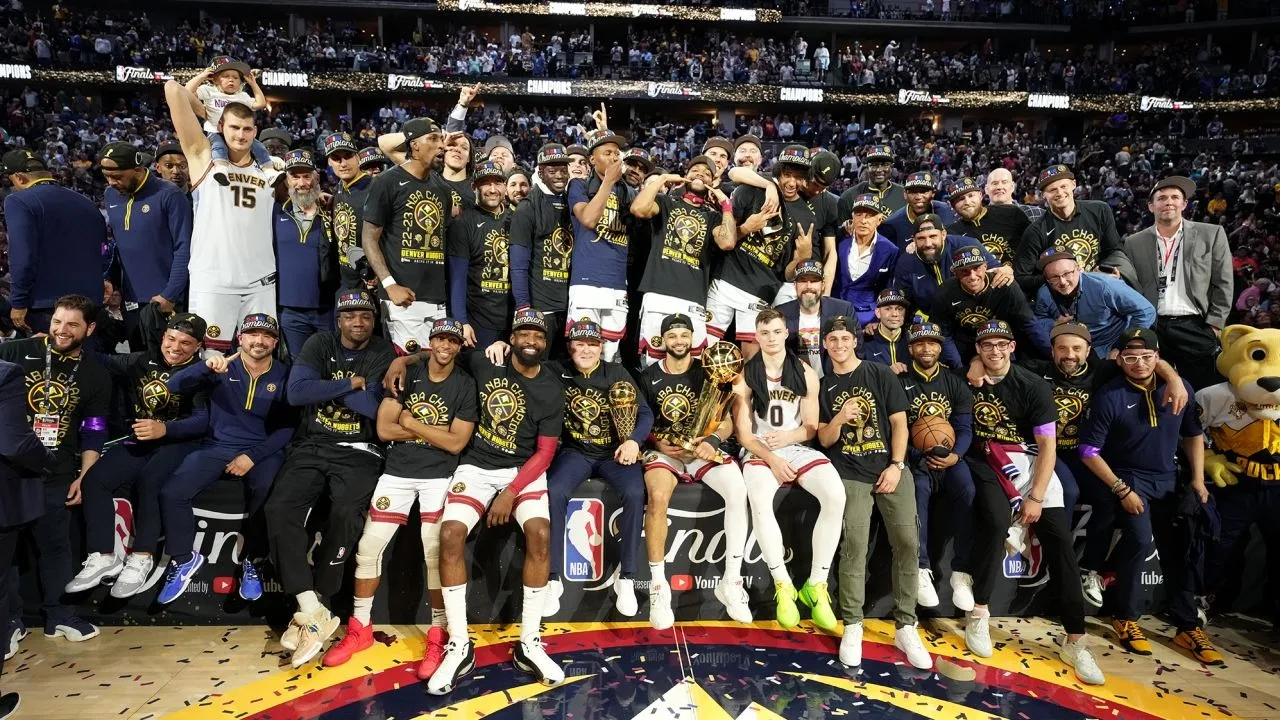 https://storage.googleapis.com/woobackup/allsoymade/2023/06/r6n6fcum-NBA-Championship-Shirts-To-Celebrate-Coach-Malone-And-MVP-Jokic-jpg.webp