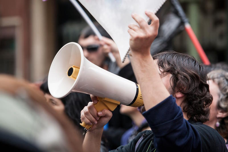 Un manifestant avec un mégaphone lors d'une journée de mobilisation
