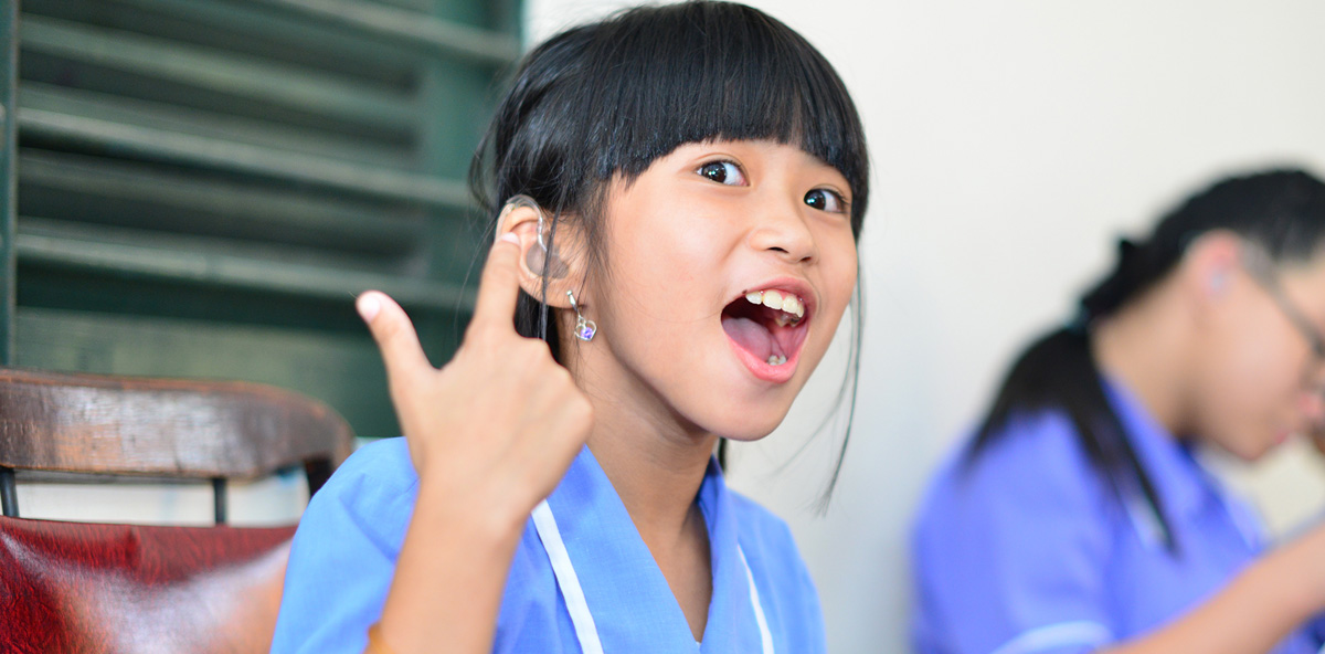 smiling-young-girl-with-her-new-hearing-aids