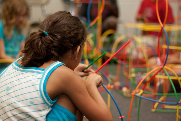 Girl in her classroom playing