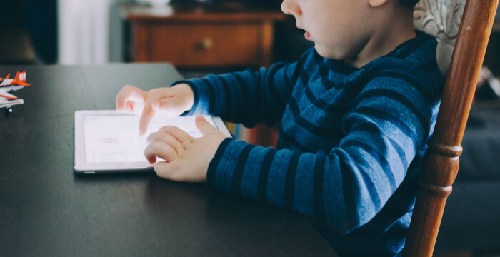 child using his tablet to learn