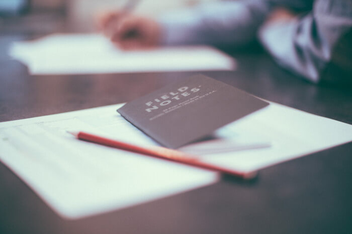 a notebook on a piece of paper with a pencil on it