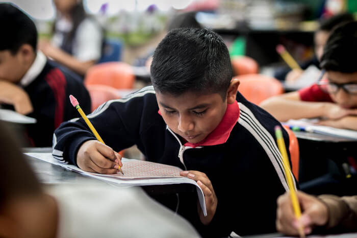 student in a classroom doing a test