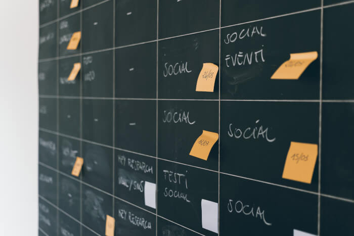 chalkboard with a schedule and some post-it on it