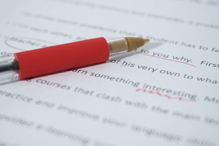 red pen on an essay with some corrections