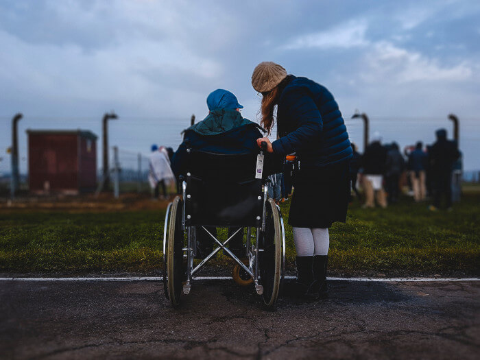 person in a wheelchair with someone next to her
